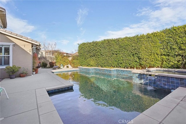 view of pool featuring an in ground hot tub and a patio area