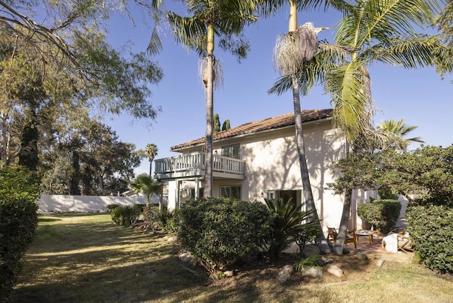 exterior space with a lawn and a balcony