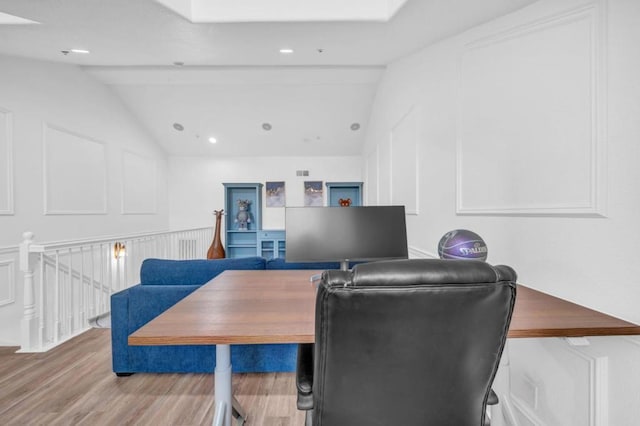 office with hardwood / wood-style flooring and vaulted ceiling with beams