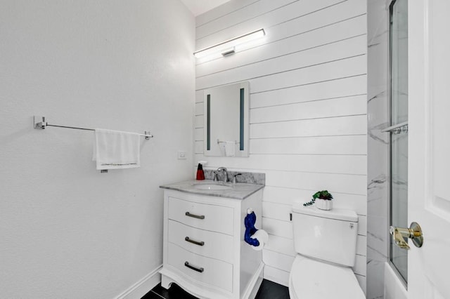 full bathroom featuring toilet, vanity, and combined bath / shower with glass door