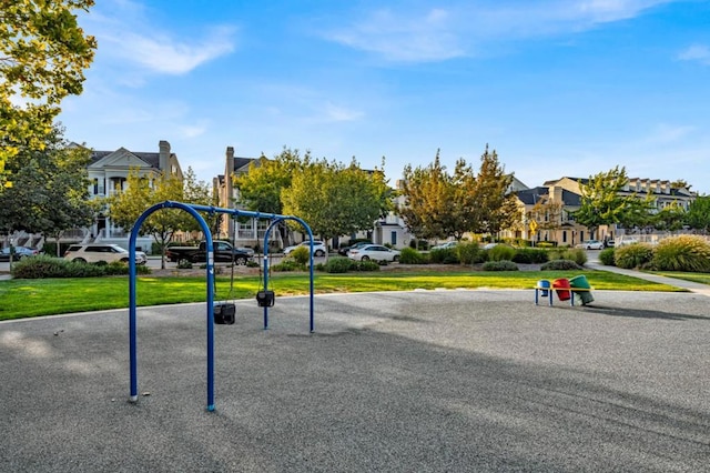 view of home's community with a yard and a playground