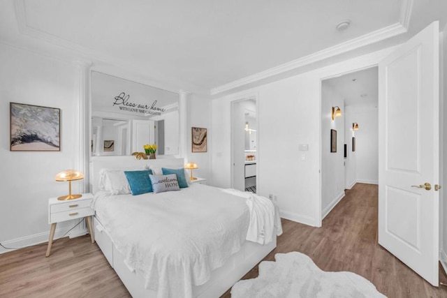 bedroom featuring light hardwood / wood-style floors and crown molding