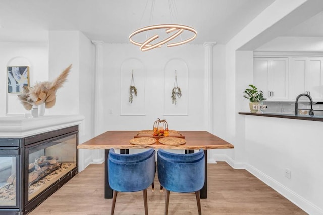 dining space with sink and light hardwood / wood-style flooring