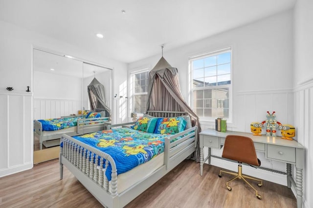 bedroom with a closet and hardwood / wood-style flooring