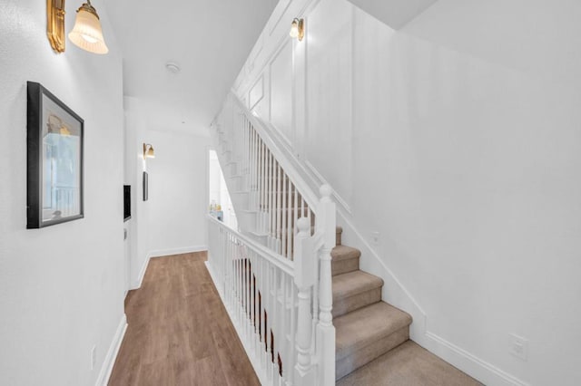 stairs featuring wood-type flooring