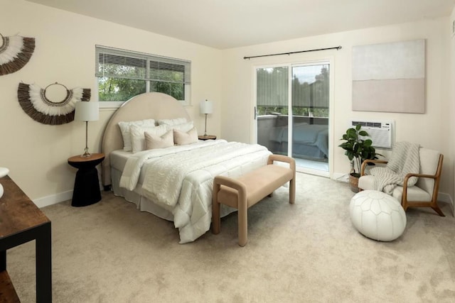 bedroom featuring multiple windows, access to exterior, light carpet, and a wall mounted AC