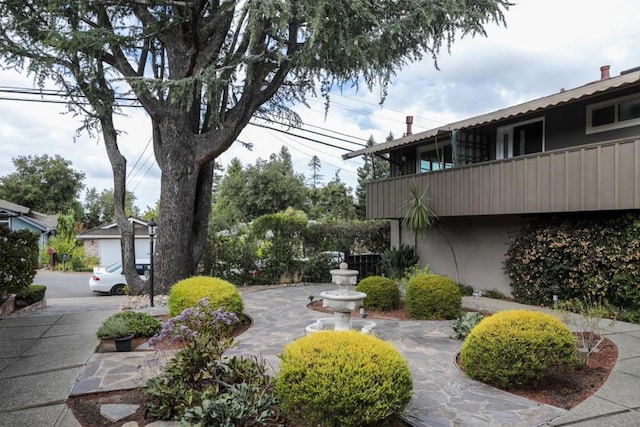 view of yard with a balcony