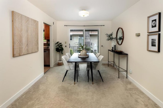 dining room featuring light colored carpet