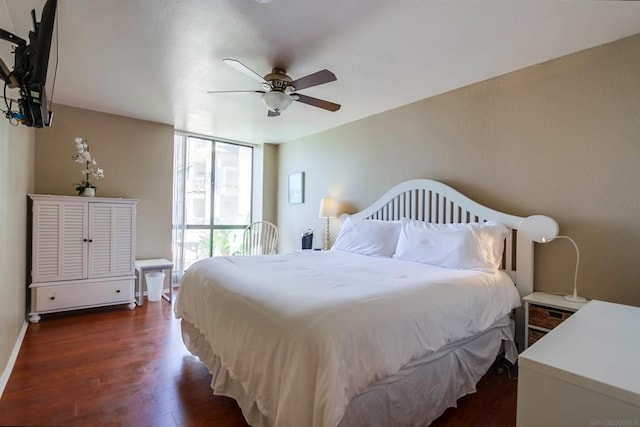 bedroom featuring ceiling fan, dark hardwood / wood-style flooring, and expansive windows