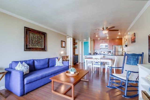 living room featuring ceiling fan, crown molding, and hardwood / wood-style flooring