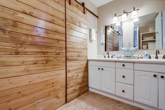 bathroom with tile patterned floors, wood walls, and vanity