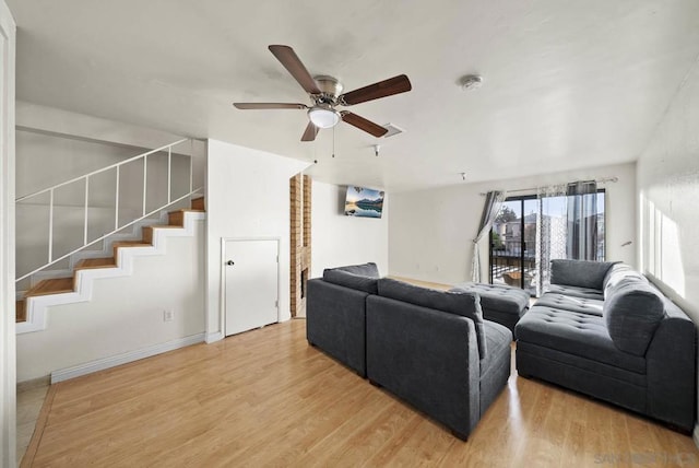 living room featuring ceiling fan and wood-type flooring