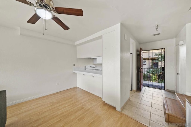 kitchen featuring ceiling fan, white cabinets, white electric range, and light wood-type flooring