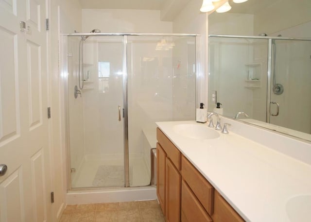 bathroom featuring tile patterned floors, walk in shower, and vanity