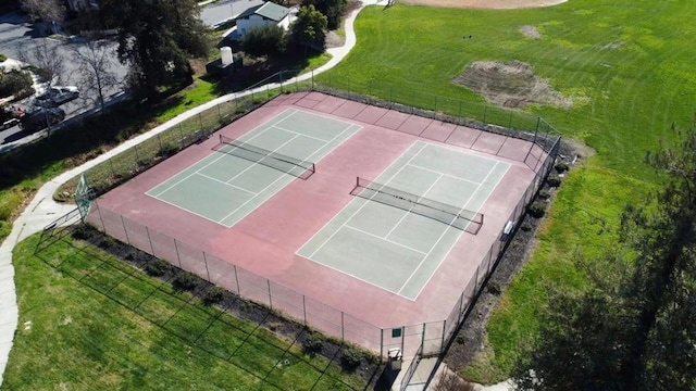 view of tennis court with a lawn