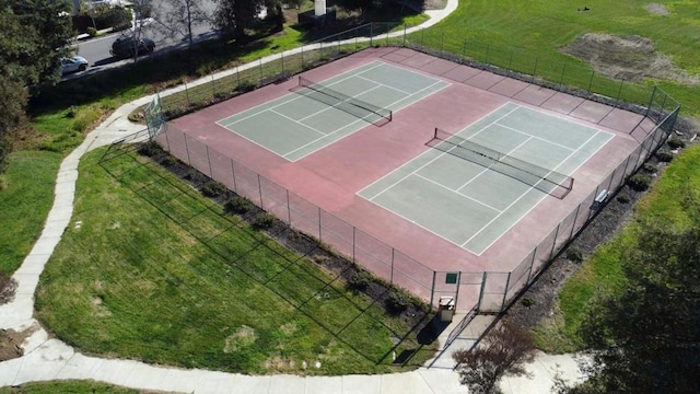 view of tennis court featuring a lawn