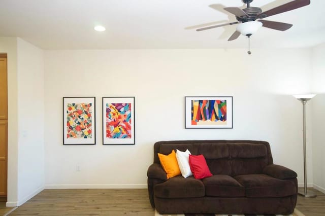 living room with ceiling fan and hardwood / wood-style floors