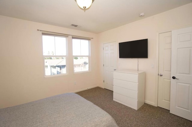 bedroom with dark carpet