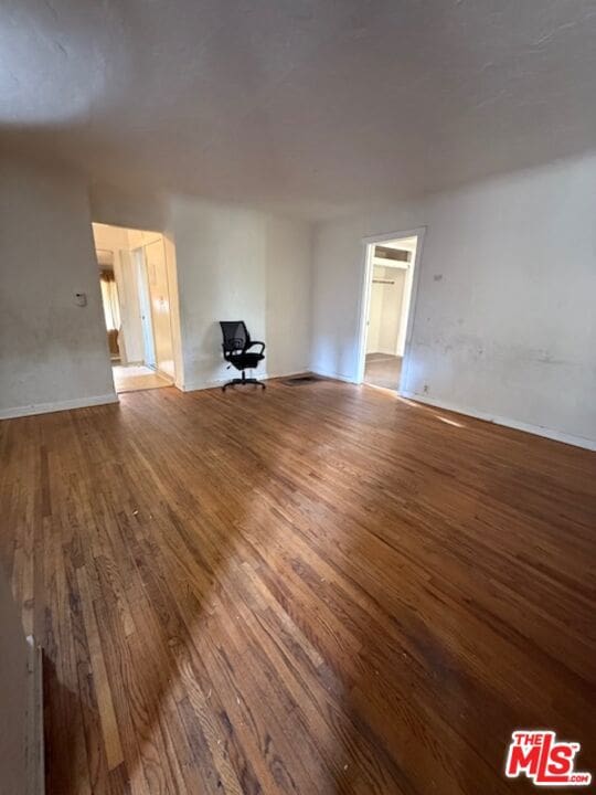 unfurnished room with hardwood / wood-style flooring