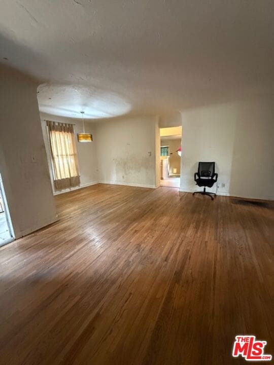 unfurnished living room featuring wood-type flooring