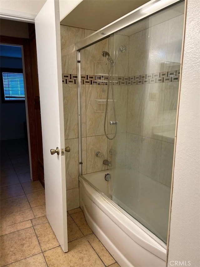 bathroom with enclosed tub / shower combo and tile patterned flooring