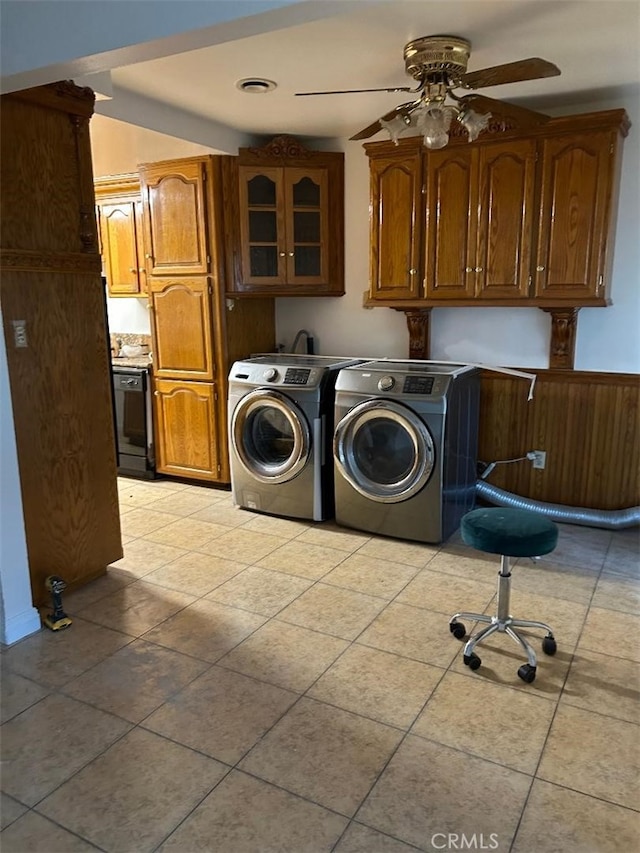 laundry room featuring cabinet space, separate washer and dryer, a wainscoted wall, and ceiling fan