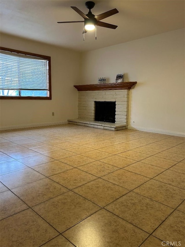 unfurnished living room featuring light tile patterned floors, a fireplace, a ceiling fan, and baseboards