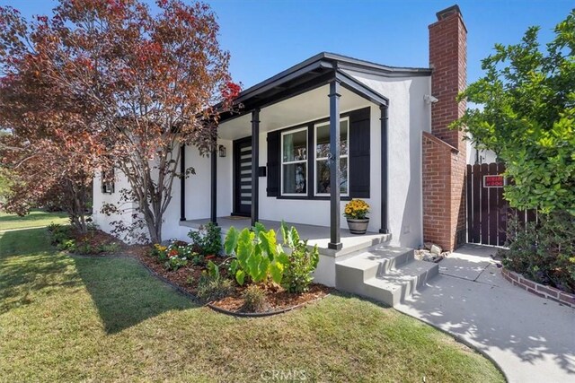 view of front of home with a front lawn and a porch