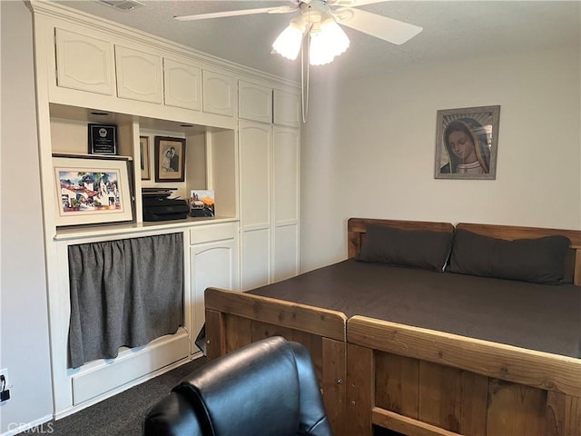 bedroom with ceiling fan, carpet, and a closet