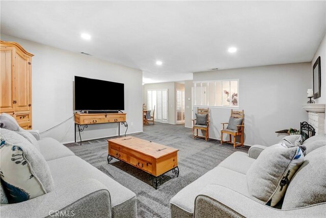 carpeted living room with a fireplace