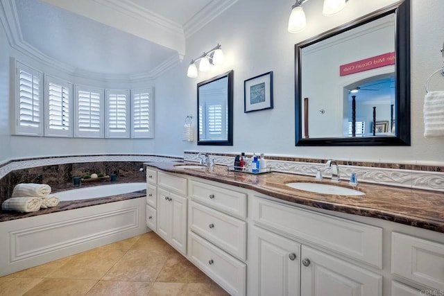 bathroom featuring ornamental molding, vanity, a washtub, a healthy amount of sunlight, and tile patterned floors