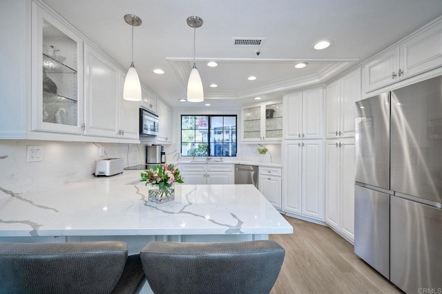 kitchen with white cabinets and appliances with stainless steel finishes