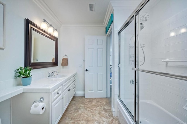 bathroom featuring crown molding, combined bath / shower with glass door, and vanity