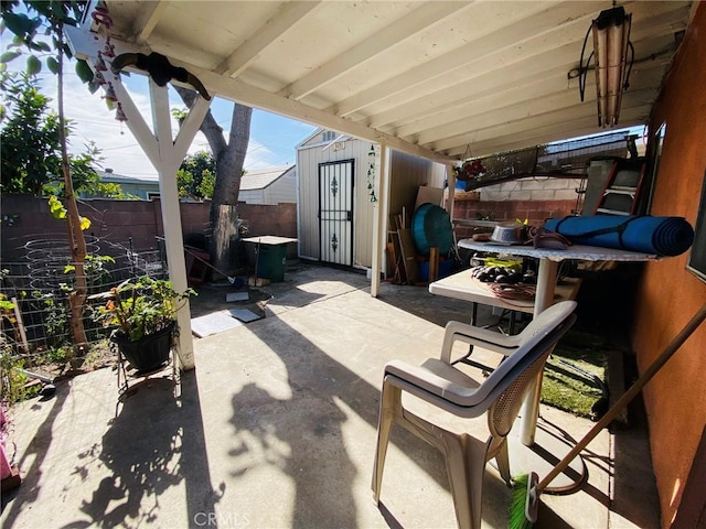 view of patio featuring a fenced backyard, a storage shed, and an outdoor structure