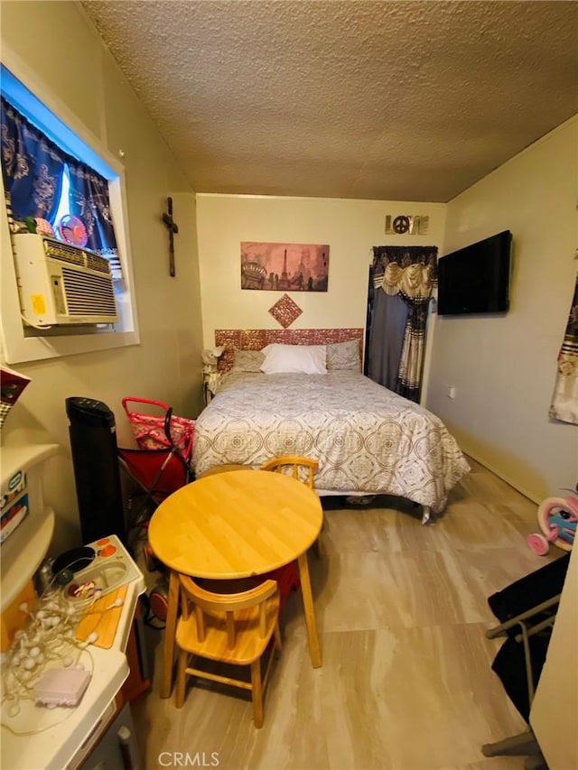 bedroom featuring cooling unit and a textured ceiling