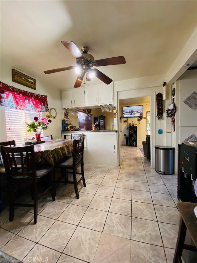 dining space featuring ceiling fan and light tile patterned flooring