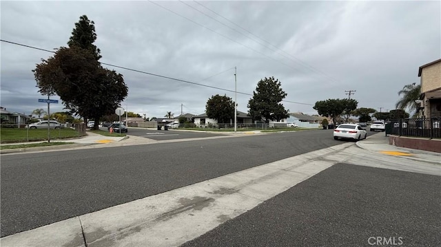 view of road with curbs, sidewalks, and a residential view