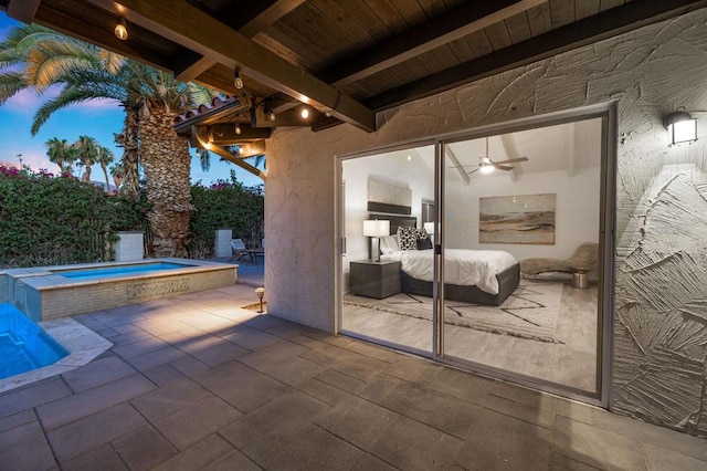 patio terrace at dusk with a hot tub