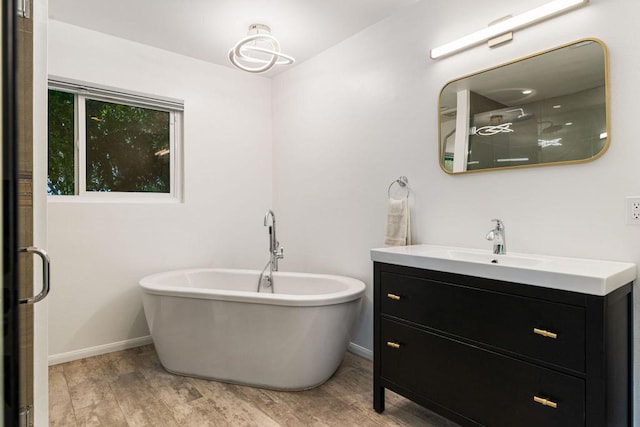 bathroom featuring wood-type flooring, vanity, and separate shower and tub