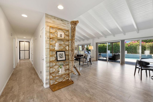 sunroom featuring vaulted ceiling with beams