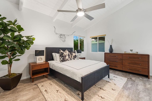 bedroom with ceiling fan, high vaulted ceiling, beamed ceiling, and light wood-type flooring