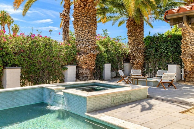 view of swimming pool with an in ground hot tub and a patio area