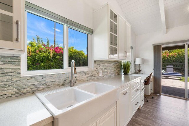 kitchen featuring backsplash, sink, white cabinetry, hardwood / wood-style flooring, and wood ceiling