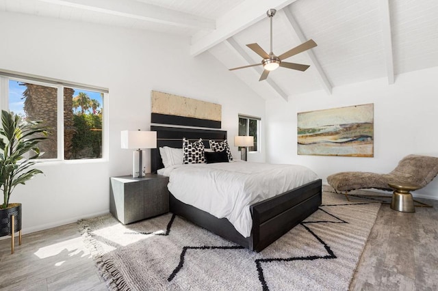 bedroom with ceiling fan, high vaulted ceiling, beamed ceiling, and light wood-type flooring