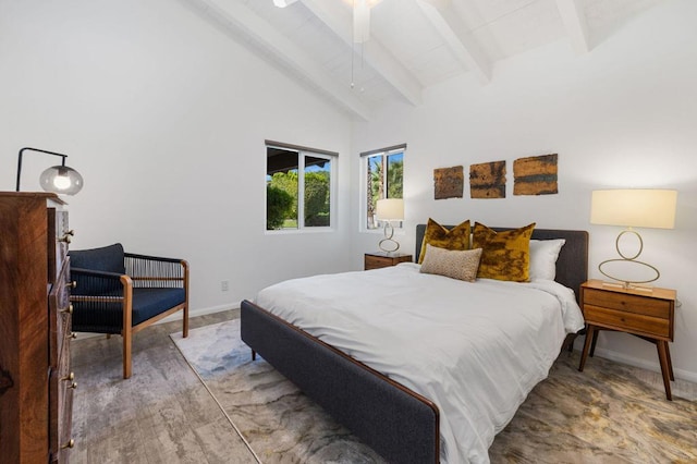 bedroom with ceiling fan and vaulted ceiling with beams