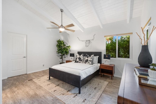 bedroom featuring ceiling fan, lofted ceiling with beams, and hardwood / wood-style flooring