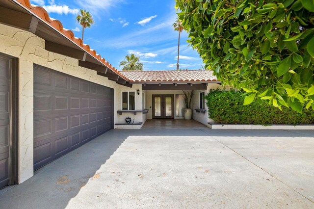 exterior space featuring french doors and a garage