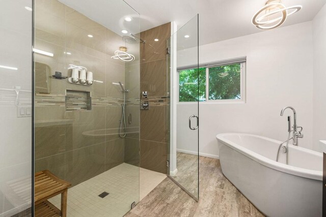 bathroom featuring shower with separate bathtub