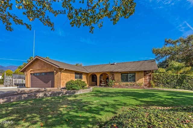 ranch-style home featuring a garage and a front lawn