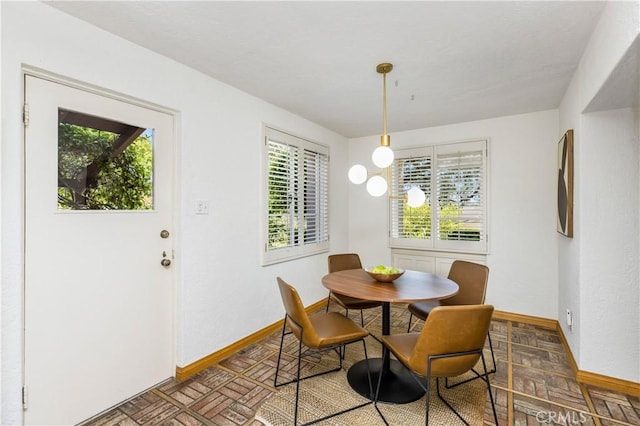 dining area featuring parquet floors and plenty of natural light